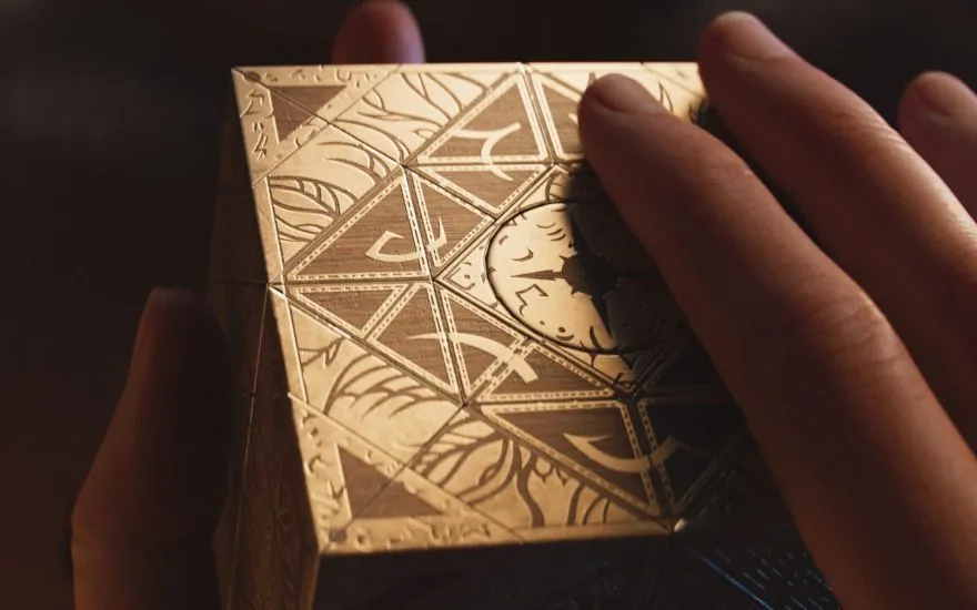 Hellraiser: Revival puzzle box held in a hand