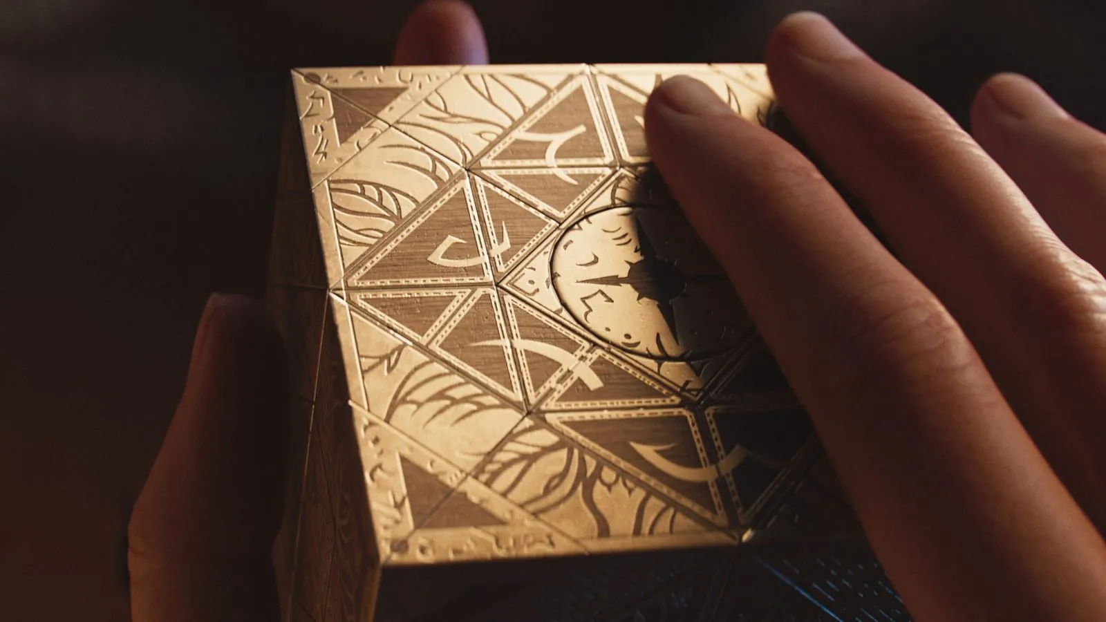 Hellraiser: Revival puzzle box held in a hand