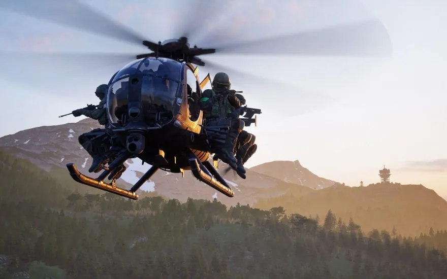 A WARDOGS helicopter crosses a mountain valley at sunset